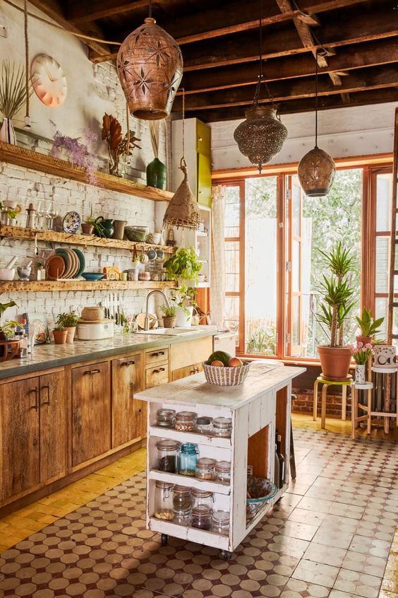 a rustic meets boho kitchen with Moroccan lanterns, wooden cabinets and a shabby chic kitchen island