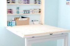 a simple and stylish Murphy desk in white and light colored wood with storage space for paints is amazing for arts and painting
