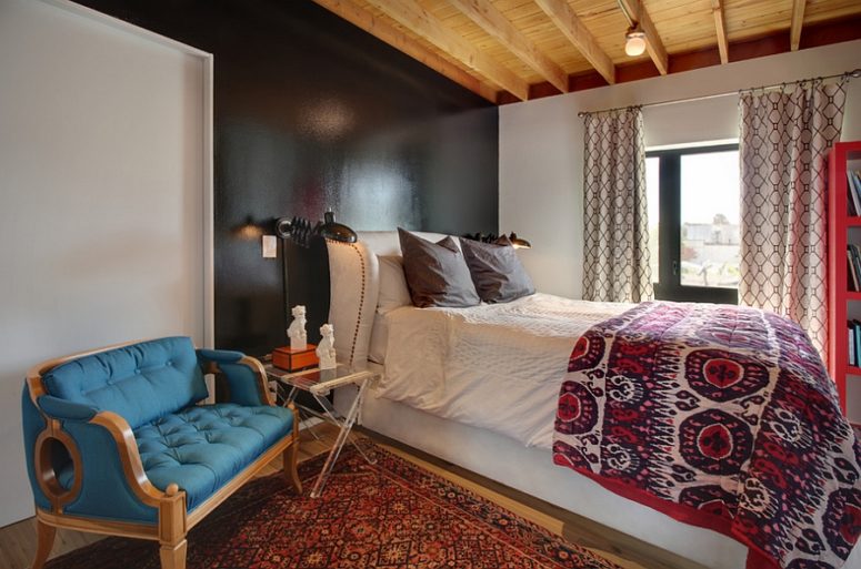 an eclectic bedroom featuring a beautiful transition between various decor styles and a mix of colors and prints