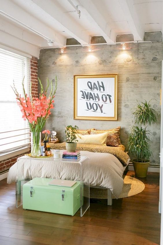 an eclectic bedroom with an animal print, bricks, an acrylic console, a mint chest and other touches of glam