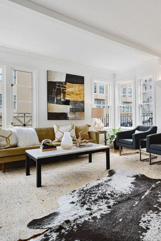 an-eclectic-light-filled-livign-room-with-graphite-grey-chairs-a-faux-animl-skin-a-statement-artwork-and-a-mustard-velvet-sofa.jpg