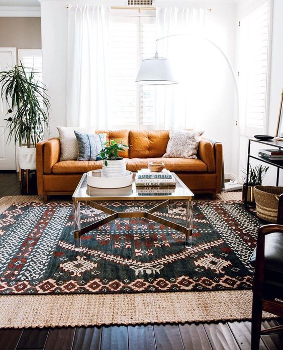 an-eclectic-living-area-with-a-folksy-rug-a-floor-lamp-a-rust-colored-sofa-and-baskets-for-storage.jpg