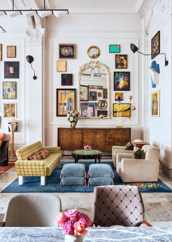 an-eclectic-living-space-with-a-large-gallery-wall-a-vintage-mirror-velvet-furniture-of-various-colors.jpg