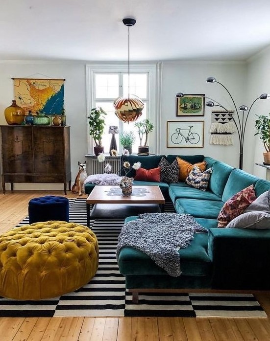an-eclectic-living-space-with-jewel-tone-furniture-a-striped-rug-a-gallery-wall-and-a-vintage-cabinet-1.jpg