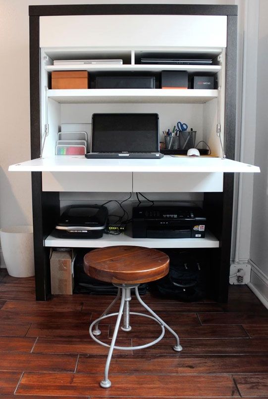 an open storage unit with documents and other office stuff and of course a Murphy desk with a laptop for comfortable working