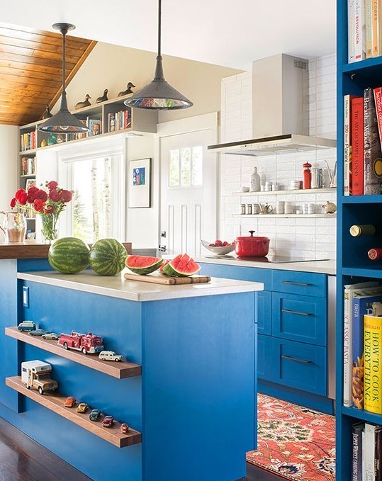bright sky blue paint on traditional Shaker style cabinets and a variety of finishes make this eclectic kitchen appealing