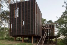 01 This contemporary house in Uruguay is clad with dark wood and amber stripes for a cathcy touch and features ocean views