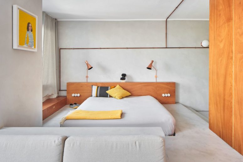 This minimalist apartment in Barcelona features concrete, warm colored wood and plywood and copper touches This minimalist apartment in Barcelona features concrete, warm colored wood and plywood and copper touches