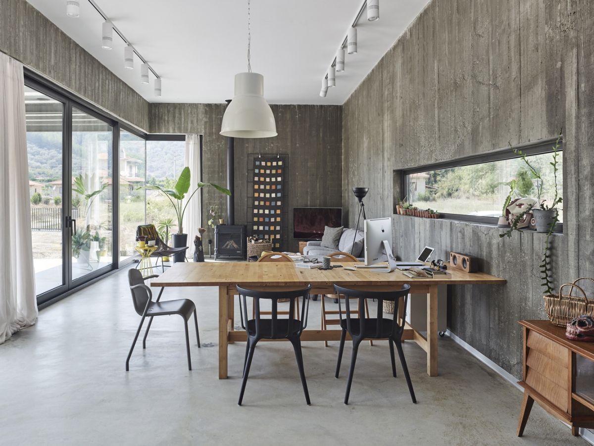 The dining or working space is done with black chairs and a wooden table