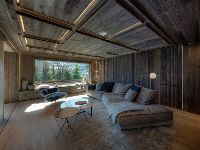 The living room is done with a large sectional sofa, a panoramic window to enjoy the views, built in lights and a faux fur chair The living room is done with a large sectional sofa, a panoramic window to enjoy the views, built-in lights and a faux fur chair