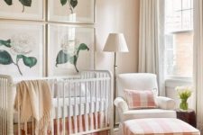 03 a cozy farmhouse nursery with peach and white plaid textiles and flower artworks may be nice for a girl’s space