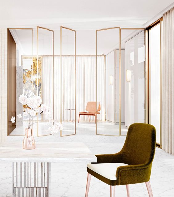 sheer glass screens with gold framing visually separate the spaces giving a slight glam feel to the space