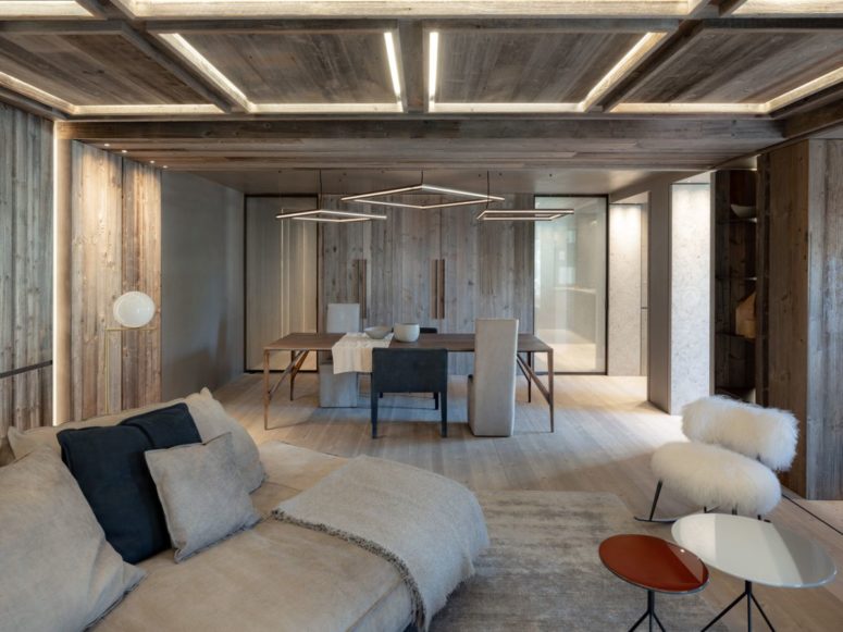 The living room seamlessly flow into the dining space done with a sleek table, upholstered chairs and some catchy frame lights The living room seamlessly flow into the dining space done with a sleek table, upholstered chairs and some catchy frame lights