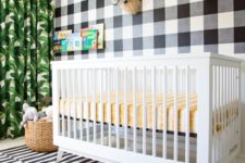 04 a fun tropical nursery with a mix of prints – a plaid statement wall, a striped rug and a tropical leaf print curtain
