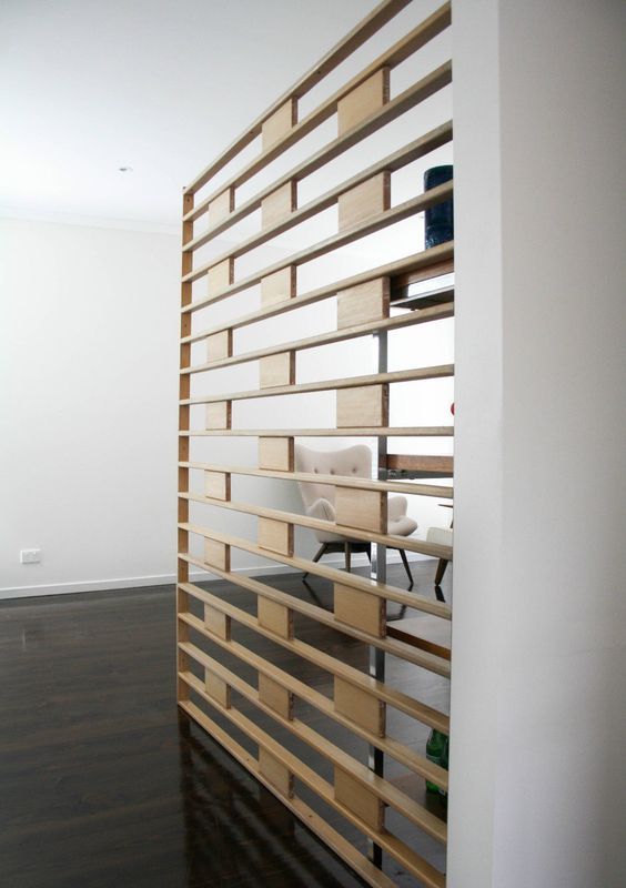 a sheer wooden screen is a cool way to separate the spaces with style and without any bulky looks
