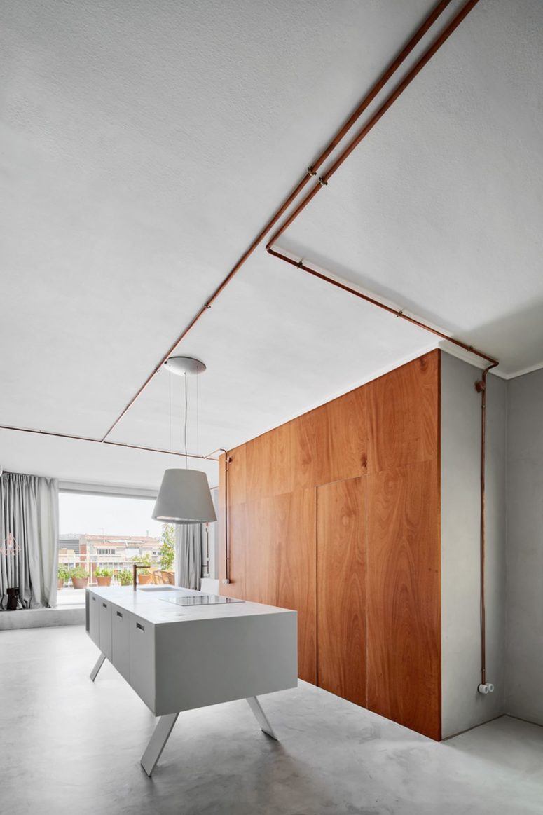The kitchen island is a large white piece done on legs to look more lightweight and a sleek storage unit The kitchen island is a large white piece done on legs to look more lightweight and a sleek storage unit