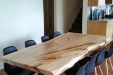 05 a laconic modern dining space with black chairs and a dining table with a live edge on black legs