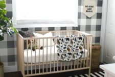 05 a stylish monochromatic nursery with a plaid wall and a striped rug plus potted plants to refresh the space