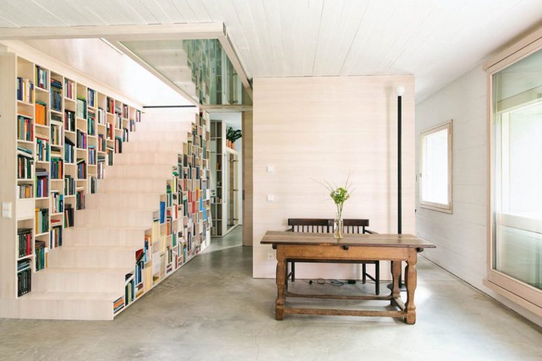 The staircase is also a bookcase, which makes the space more functional and the storage space isn't necessary The staircase is also a bookcase, which makes the space more functional and the storage space isn't necessary