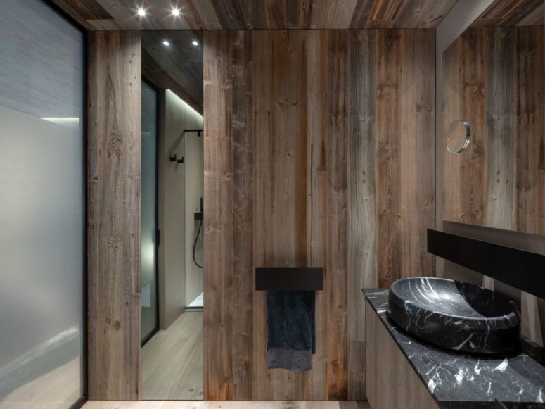 The same reclaimed wood was even used on some of the bathroom walls as a way of maintaining a cohesive look throughout the house The same reclaimed wood was even used on some of the bathroom walls as a way of maintaining a cohesive look throughout the house