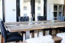 07 a live edge dining table and a matching reclaimed wood bench contrast the chic blue chairs
