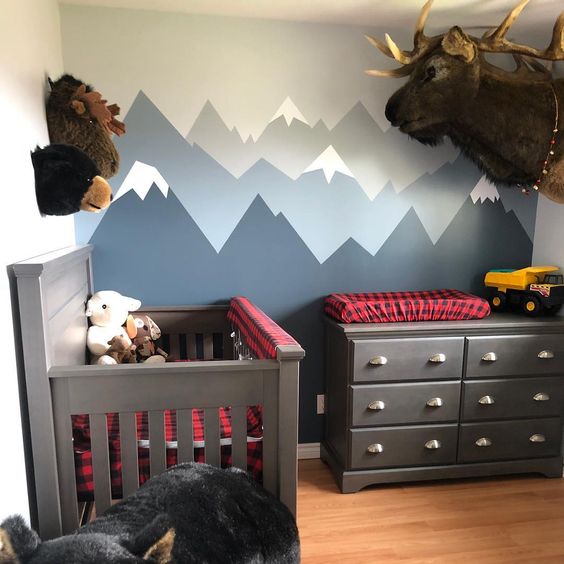 a woodland inspired nursery with red and navy plaid textiles that add print and color to the space