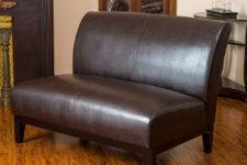 08 a loveseat of brown leather, with stained wooden legs will make an accent not only with its look but also with a texture