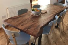 08 a modern dining room with a live edge dining table with grey chairs is very chic and cozy