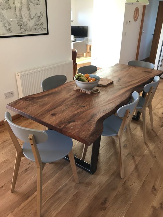 a modern dining room with a live edge dining table with grey chairs is very chic and cozy