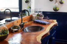 09 a navy vanity with a contrasting warm-stained live edge wooden countertop that brings a natural touch to the space