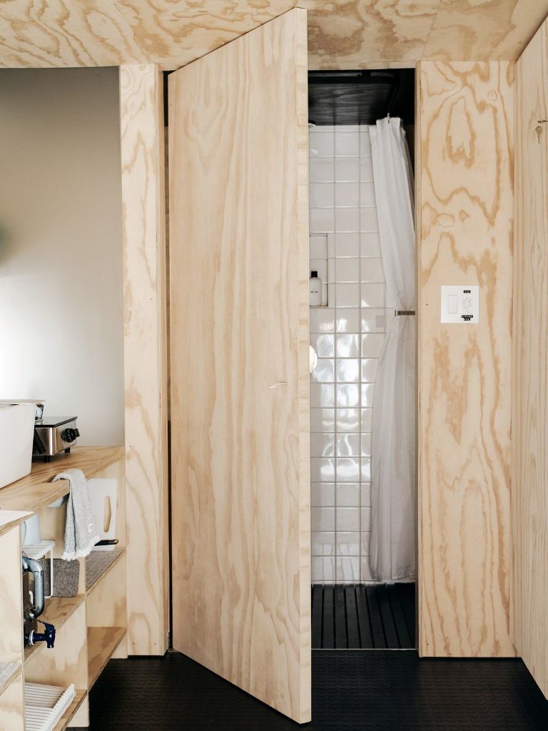 a coo small bathroom design A tiny bathroom is situated next to the kitchen and features a frosted glass wall which lets light pass through