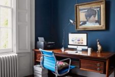 10 a stylish home office with navy walls, stucco, a vintage wooden desk and an animal skin rug