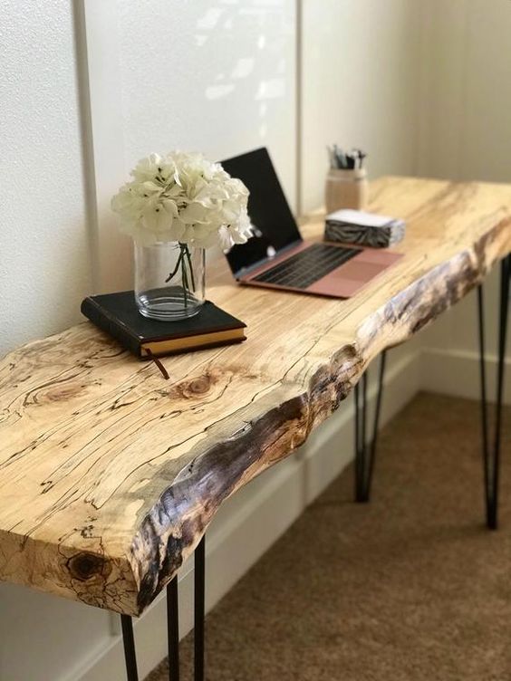 a sleek live edge desk with hairpin legs features two trends in one and can be also used as a console table