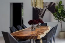 14 a super elegant and modern dining space with black geometric chairs, a live edge dining table and gilded touches