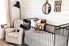 15 a farmhouse nursery with a woodland boho gallery wall, a printed rug and dramatic black touches
