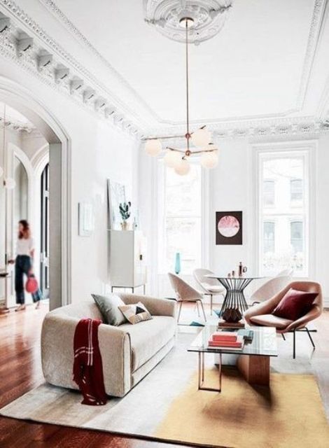 chic molding on the walls and a ceiling medallion make the living room chic