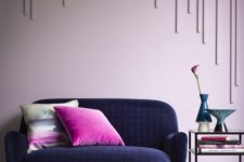 16 a statement navy loveseat of textural velvet, bright pink pillows create a starck contrast and catch an eye