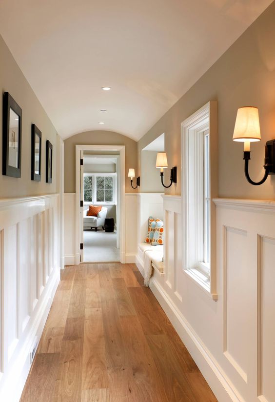 built-in lights paired with elegant retro wall sconces brign much light and make the space welcoming