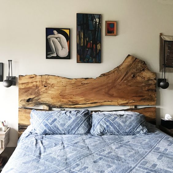 a bed with a statement live edge headboard, which brings a natural feel and makes the bedroom a bit boho