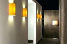 19 minimalist yellow wall sconces add color to the space and make the hallway lit up enough, though not too much