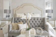 20 a super elegant grey tufted loveseat with a tall bench to create a sitting space at the bed
