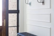 21 black and white sconces match the black bench and make the hallway chic and bold