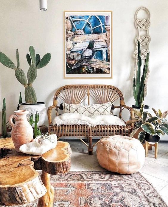 a boho desert living room finished off with a rattan loveseat with soft fur and a tassel pillow
