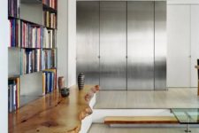 23 a white credenza with a live edge stained wooden countertop that makes the minimalist space cozy and a bit rustic