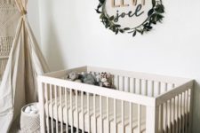 23 the name placed on the wall and accented with a fake greenery wreath is a stylish idea for a gender-neutral nursery