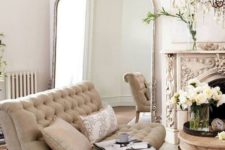 25 a super ornate fireplace and a crystal chandelier make this neutral space truly Parisian and tres chic