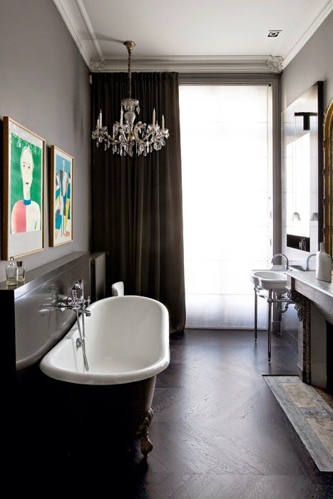 a chic contemporary meets vintage bathroom in chocolate browns, with a crystal chandelier, a clawfoot bathtub and a free standing sink a chic contemporary meets vintage bathroom in chocolate browns, with a crystal chandelier, a clawfoot bathtub and a free-standing sink