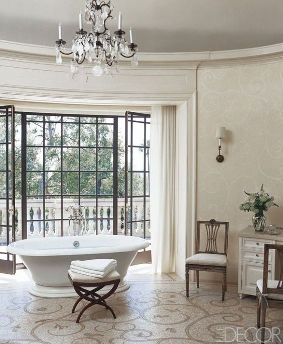 a neutral Parisian bathroom with a crystal chandelier, a chic vintage bathtub, a patterned floor and elegant furniture a neutral Parisian bathroom with a crystal chandelier, a chic vintage bathtub, a patterned floor and elegant furniture
