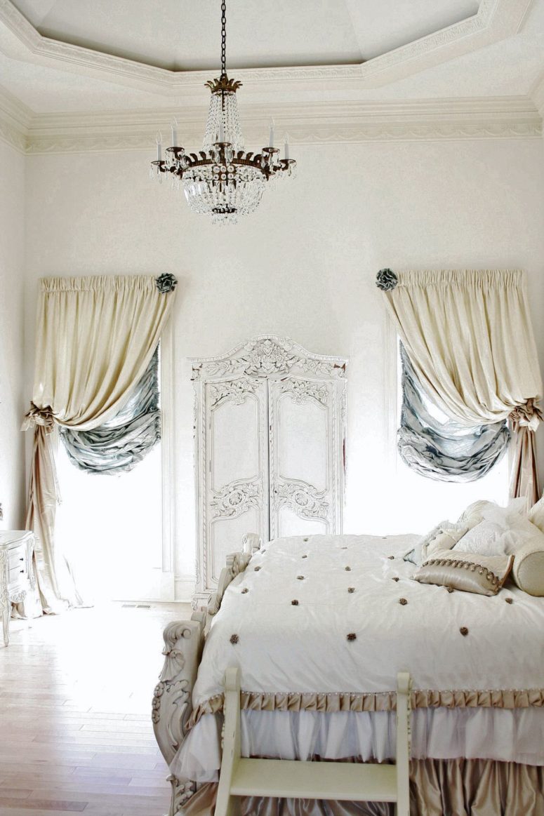 an antique-inspired Parisian bedroom in neutrals and soft touches of blue, with sophisticated furniture and chic draperies