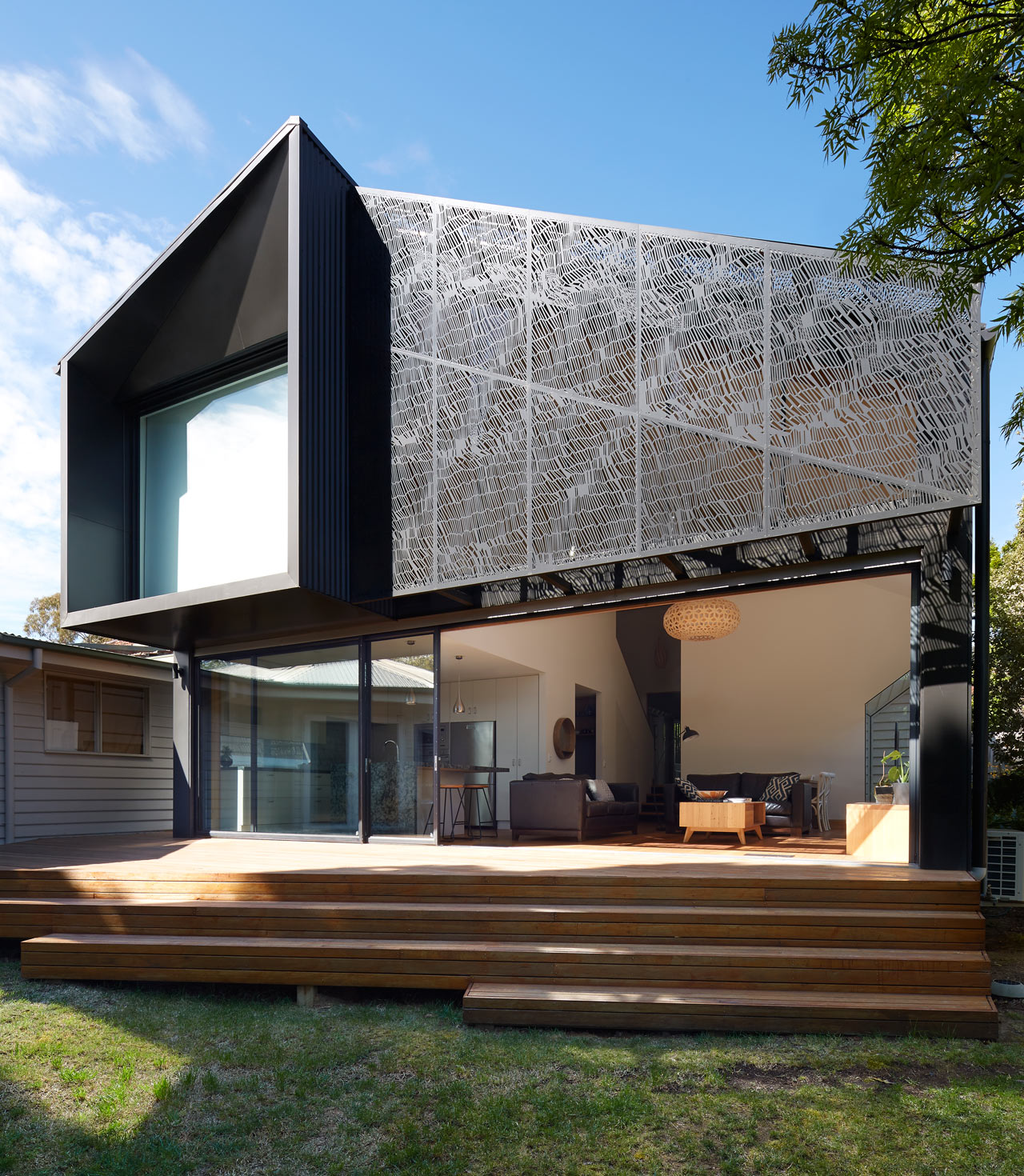 This gorgeous contemporary house addition was done with pretty geometry and a cool screen inspired by textiles, it's used to prevent excessive sunshine in